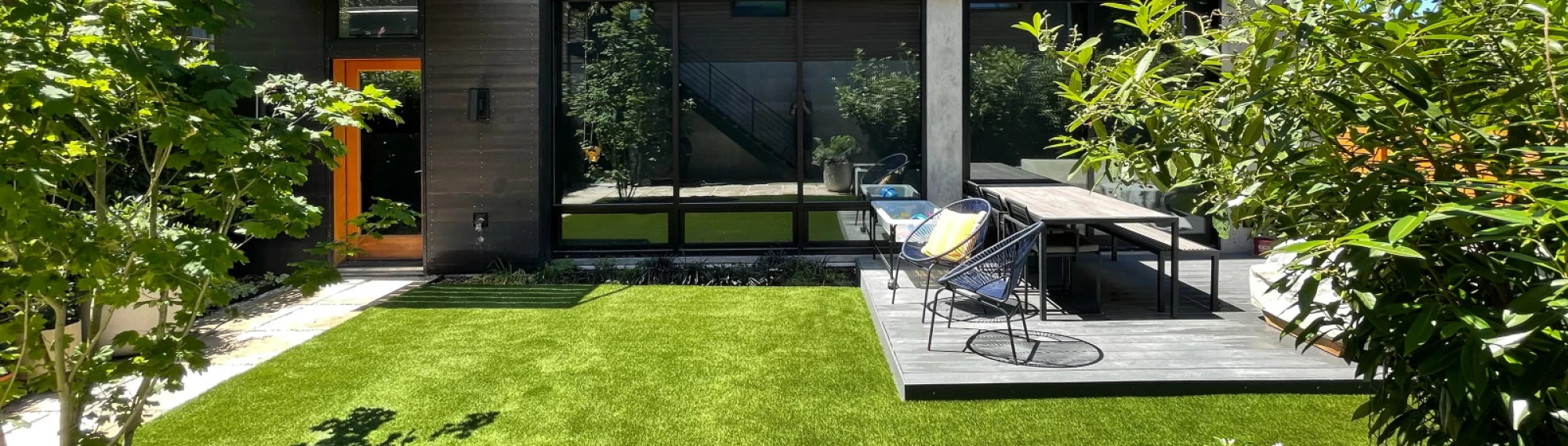 Aerial view of a modern home in Washington state with a large synthetic grass yard