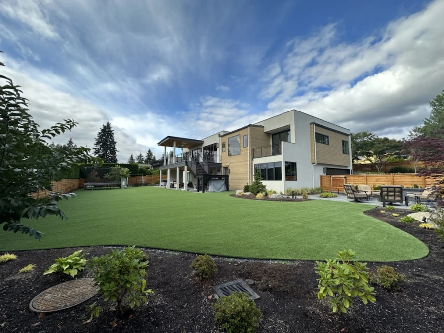 Large Modern Home in Bellevue, WA with expansive pet friendly synthetic turf backyard.
