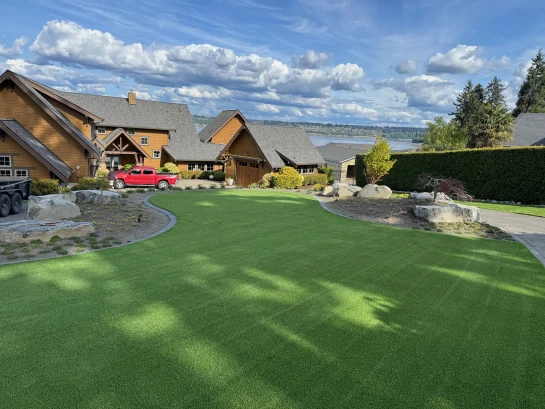 Tall pile height artificial grass installed in Gig Harbor front yard with salt water in background.