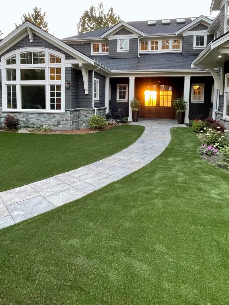 Lush artificial grass front yard installation in Bellevue with green synthetic turf glowing in golden sunset light
