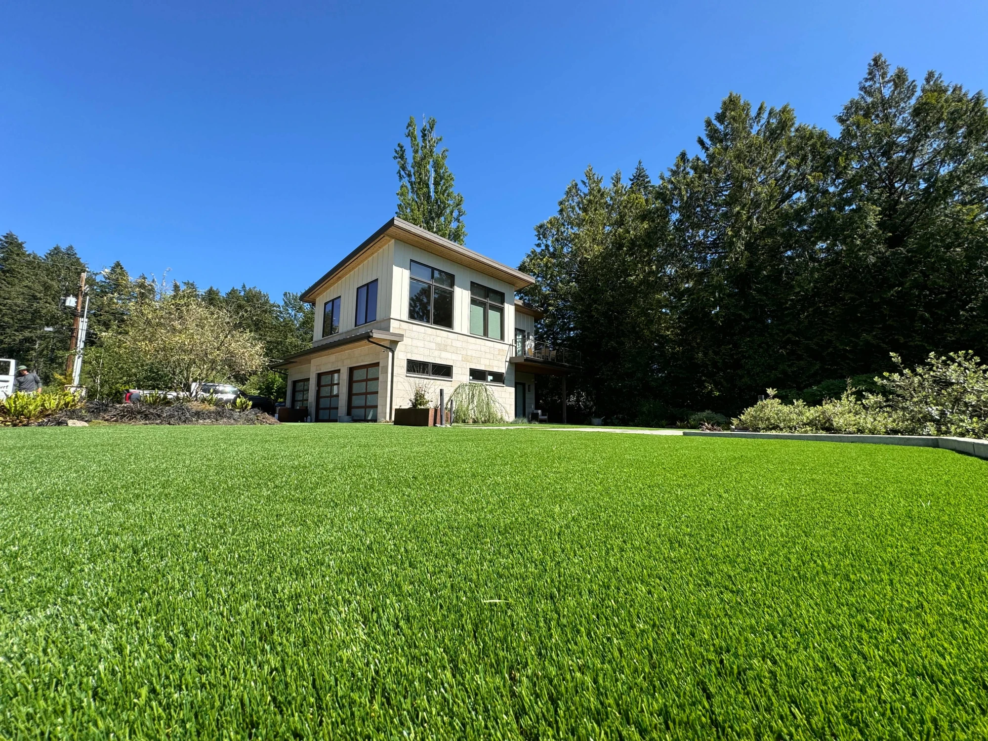 Pristine synthetic turf lawn installation next to golf course in Gig Harbor, Washington State showcasing professional landscaping